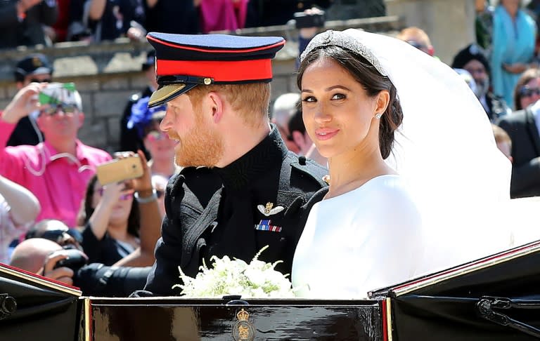 The royal couple waved to well-wishers as they headed for a reception after the wedding ceremony