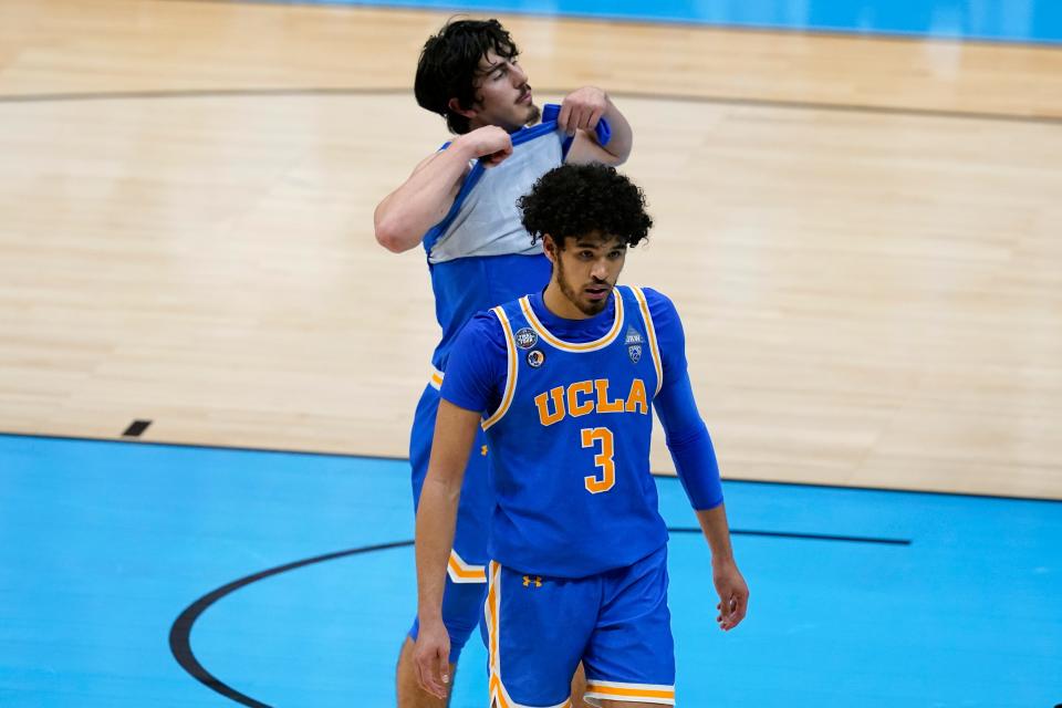 UCLA guard Johnny Juzang (3) and guard Jaime Jaquez Jr., rear, walk off the court after a men's Final Four NCAA college basketball tournament semifinal game against Gonzaga , Saturday, April 3, 2021, at Lucas Oil Stadium in Indianapolis. Gonzaga won 93-90 in overtime.