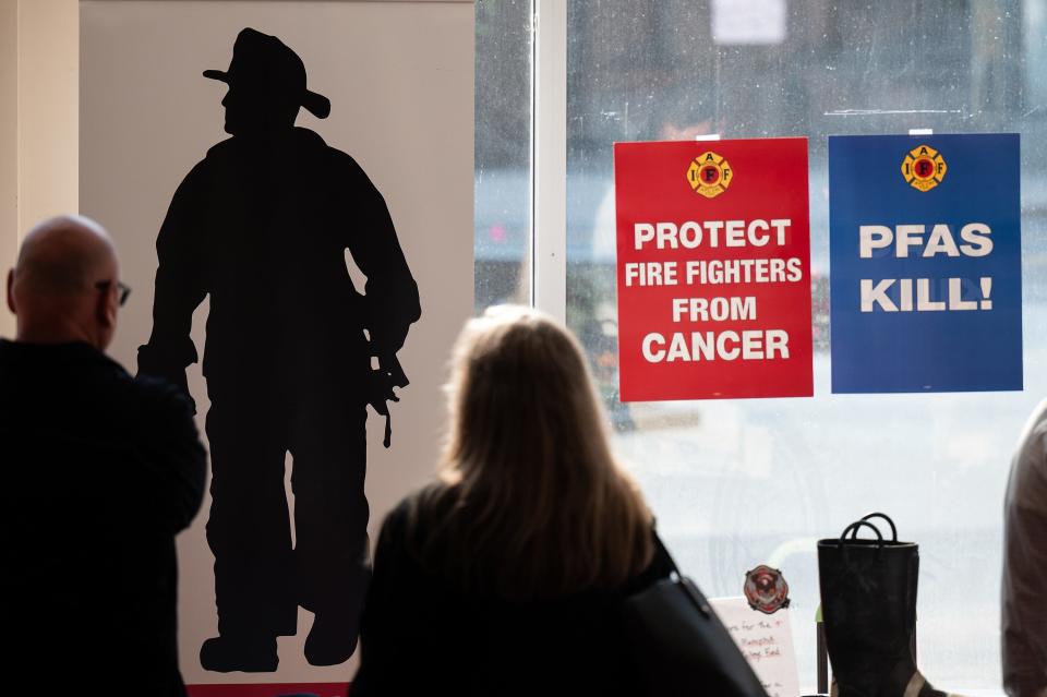 Signs adorn the windows prior to the screening of "Burned," a film that tells the story of Diane Cotter of Worcester's fight to expose PFAS in firefighting gear on Sunday June 11, 2023 at the Hanover Theatre.