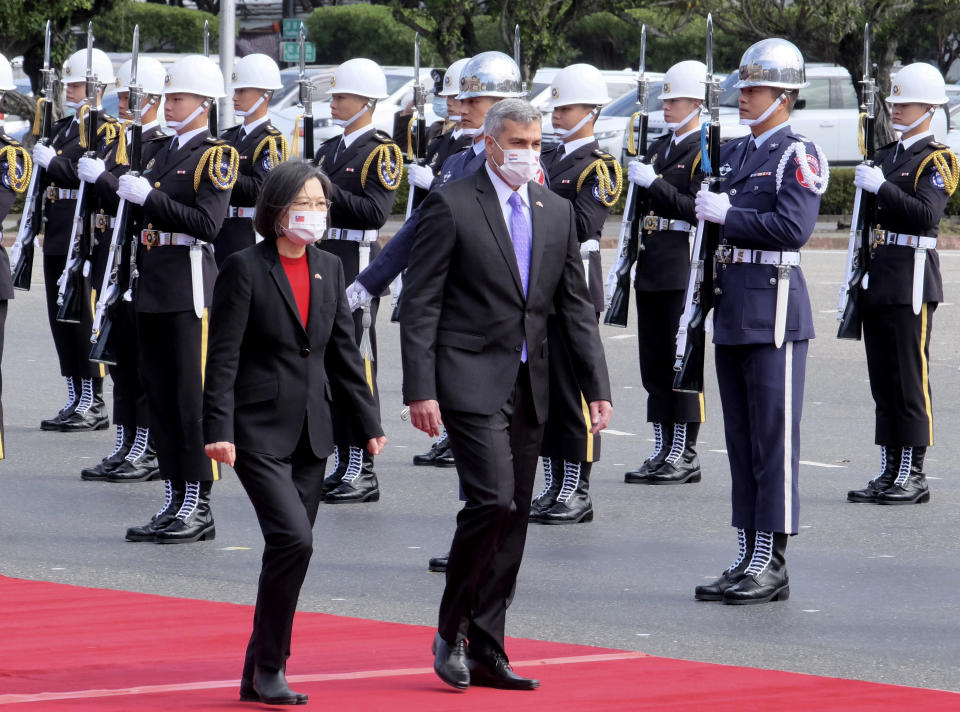 Taiwan's President Tsai Ing-wen, left, and Paraguay's President Mario Abdo Benitez walk past an honor guard at the Presidential House in Taipei, Taiwan, Thursday, Feb. 16, 2023. The outgoing president of Paraguay, whose country is one of Taiwan's few remaining diplomatic allies, spoke of his admiration of the island's democracy Thursday while on a state visit. (AP Photo/Johnson Lai)