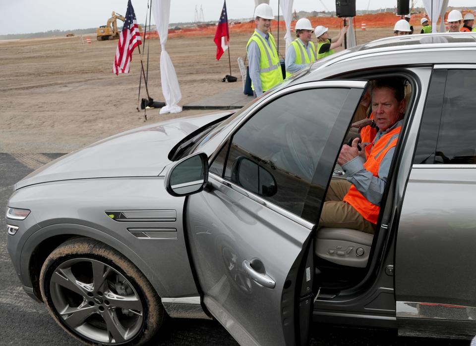Georgia Governor Brian Kemp gives a thumbs up as he gets behind the wheel of a Hyundai Genesis on Friday, May 5, 2023 at the future site of the Hyundai Meta Plant in Ellabell, Georgia.
