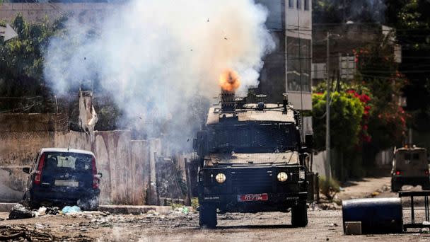 PHOTO: An Israeli armoured vehicle fires tear gas during an ongoing military operation in Jenin city in the occupied West Bank, July 4, 2023. (Ronaldo Schemidt/AFP via Getty Images)