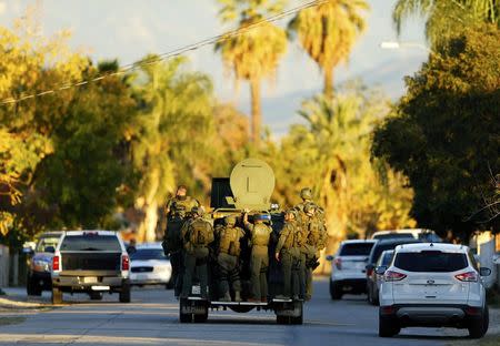 Police officers conduct a manhunt after a mass shooting in San Bernardino, December 2, 2015. REUTERS/Mike Blake