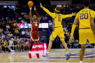 Alabama guard Latrell Wrightsell Jr. (12) shoots a three point basket against LSU guard Mike Williams III (2) during the second half of an NCAA college basketball game in Baton Rouge, La., Saturday, Feb. 10, 2024. (AP Photo/Matthew Hinton)