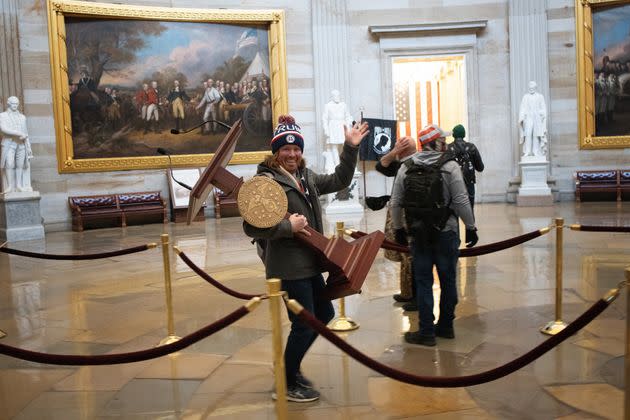 Adam Johnson carries the lectern of Speaker of the House Nancy Pelosi through the Rotunda of the U.S. Capitol Building after a pro-Trump mob stormed the building on Jan. 6, 2021, in Washington, D.C.  (Photo: Win McNamee via Getty Images)