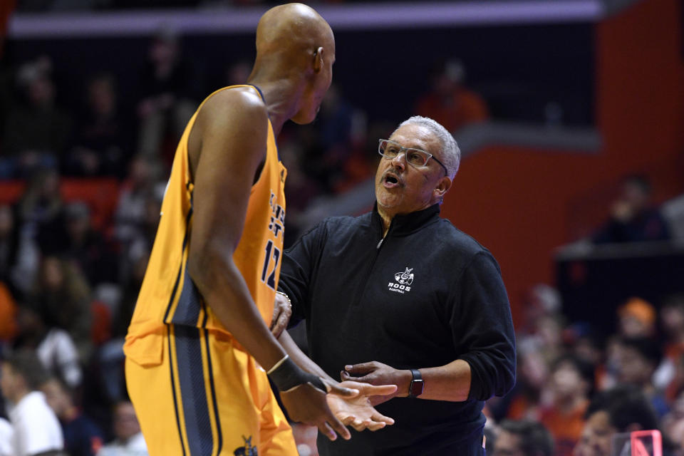 UMKC coach Marvin Menzies talks with Promise C. Idiaru during the second half of the team's NCAA college basketball game against Illinois on Friday, Nov. 11, 2022, in Champaign, Ill. (AP Photo/Michael Allio)