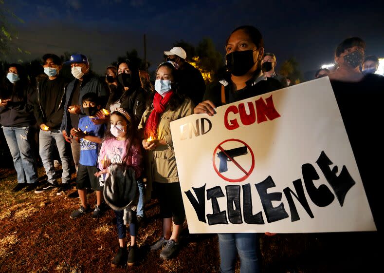 PASADENA, CALIF. - NOV. 22, 2021. Residents of the Villa Parke neighborhood of Pasadena gather for a candlelight vigil for shooting victim Iran Moreno-Balvaneda on Monday night, Nov. 22, 2021. Iran, 13, was killed by a stray bullet as he played video games inside his home. Authorities are investiogating the shooting, one of many in Villa Parke in recent months. ( Luis Sinco / Los Angeles Times)