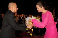 <p>Being gifted flowers by Cambodian King Norodom Sihamoni at the 2017 premiere of her film <em>First They Killed My Father</em>. </p>
