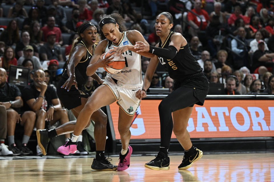 New York Liberty forward Betnijah Laney drives past Las Vegas Aces guard Jackie Young and forward A'ja Wilson during Game 1 of the 2023 WNBA Finals at Michelob Ultra Arena in Las Vegas on Oct. 8, 2023. (Candice Ward/USA TODAY Sports)