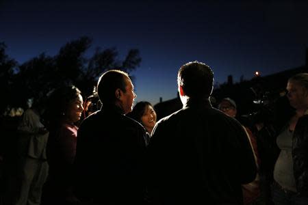 Darren Black Bear (C) and Jason Pickel (R) are interviewed after being married by Darren's father Rev. Floyd Black Bear in El Reno, Oklahoma October 31, 2013. REUTERS/Rick Wilking