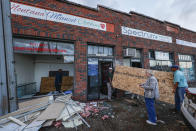 Workers prepare to board up windows as they recover from a tornado that passed through downtown Selma, Ala., Thursday, Jan. 12, 2023. (AP Photo/Butch Dill)