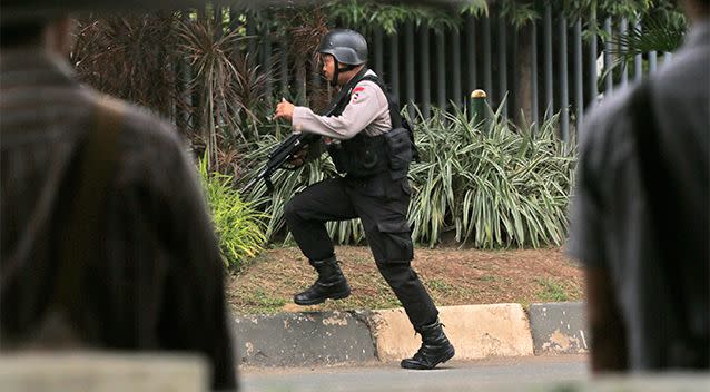 A police officer takes his position near the site where an explosion went off in Jakarta. Photo: AP