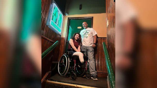 PHOTO: Sydney Benes with head of security Nate Sanders at Sullivan's Pub. Sanders said Benes is looking to press charges against the two men who pushed her chair down the stairs and damaged it. (Julia Zukowski)