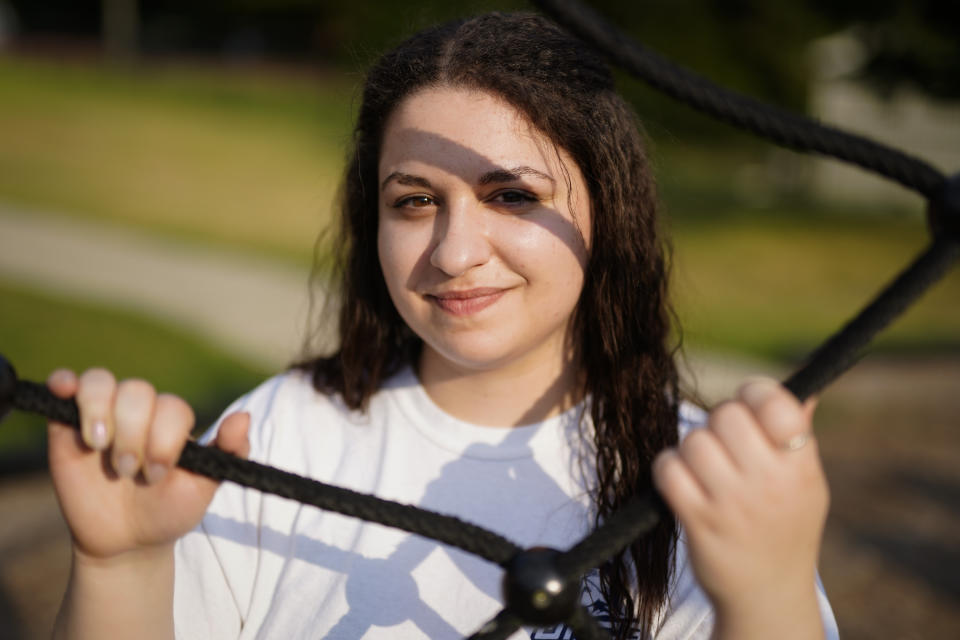 Laura Comino, a senior at the University of North Carolina at Greensboro poses for a picture on Tuesday, July 14, 2020, in Charlotte, N.C. College students are getting ready to return to school in August as the country deals with the coronavirus pandemic. More and more campuses are sparking frustration by releasing plans to keep students' housing payments, even if the campuses shut down again and go entirely online in the fall. (AP Photo/Chris Carlson)