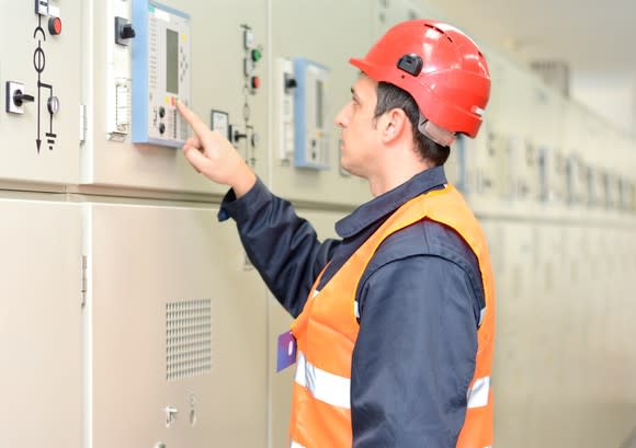 A man examining industrial electric equipment