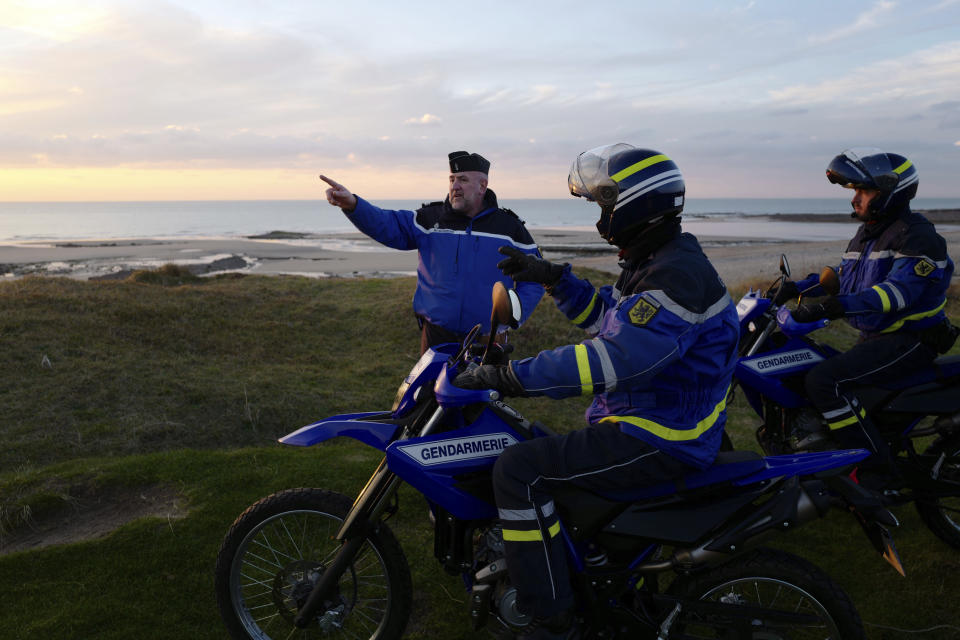 French gendarmes patrol the beach in Ambleteuse near Calais, northern France, Friday, Jan. 18, 2019. Land, sea and air patrols are combing the beaches, dunes and frigid, murky coastal waters of northern France in a bid to end an unusual high-risk tactic by migrants, mostly Iranians: trying to sneak across the English Channel in rubber rafts. (AP Photo Michel Spingler)