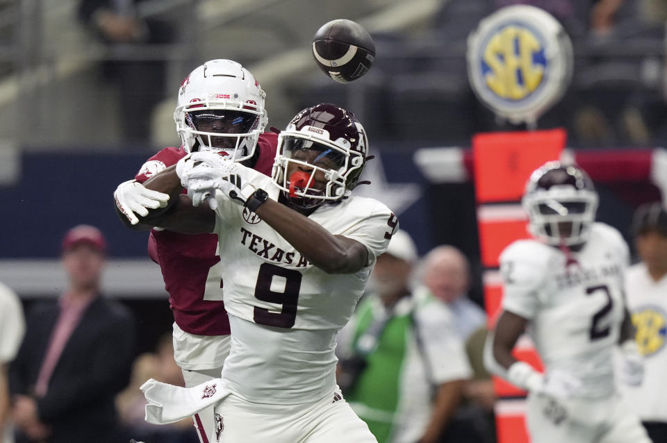 Arkansas defensive back Dwight McGlothern (2) breaks up a pass intended for Texas A&M wide receiver Jahdae Walker (9) during the first half of an NCAA college football game in Dallas, Saturday, Sept. 30, 2023. (AP Photo/LM Otero)