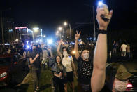 People gather during a mass protest following presidential elections in Minsk, Belarus, Monday, Aug. 10, 2020. Thousands of people have protested in Belarus for a second straight night after official results from weekend elections gave an overwhelming victory to authoritarian President Alexander Lukashenko, extending his 26-year rule. A heavy police contingent blocked central squares and avenues, moving quickly to disperse protesters and detained dozens. (AP Photo/Sergei Grits)