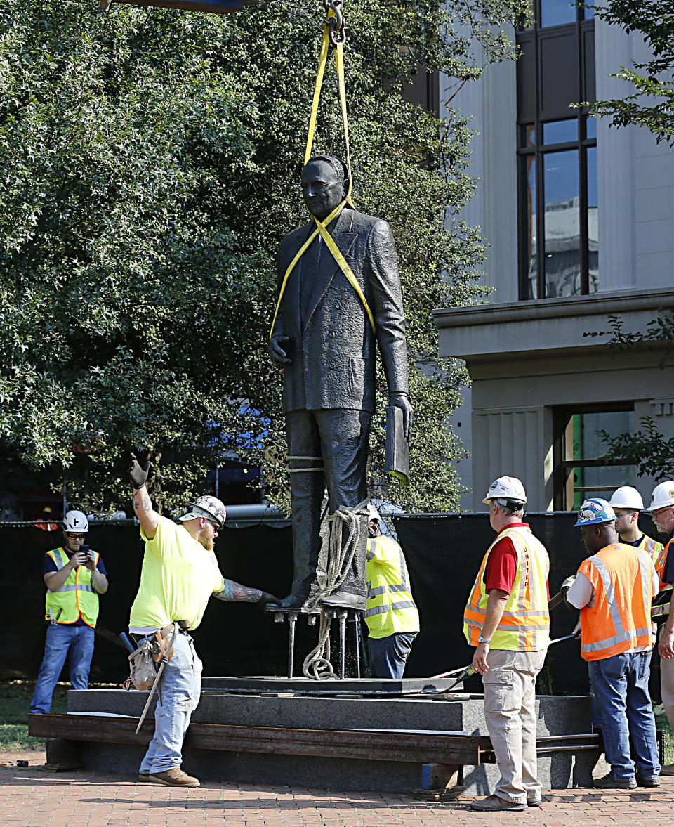 The statue of Harry F. Byrd, Sr., former Virginia Governor and U. S. Senator, is removed from the pedestal in Capitol Square in Richmond, Va. Wednesday, July 7, 2021. The General Assembly approved the removal during the last session. (Bob Brown/Richmond Times-Dispatch via AP)