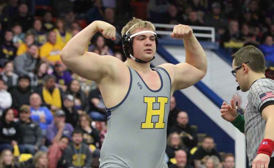 Hartland heavyweight Vincent Cox flexes after winning by pin in the first match of the state semifinal dual against Rockford on Saturday, Feb. 25, 2023 at Wings Event Center.