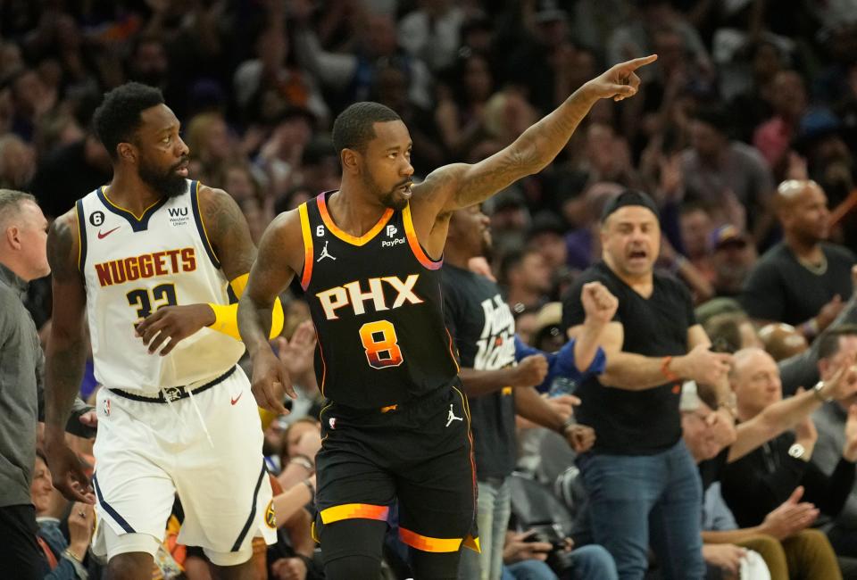 Phoenix Suns guard Terrence Ross (8) points after a three-point basket against the Denver Nuggets during the third quarter of Game 4 of the Western Conference Semifinals at Footprint Center on May 7, 2023.