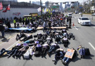 Members of the Korean Confederation of Trade Unions stage die-in during a rally marking International Women's Day in Seoul, South Korea, Friday, March 8, 2024. (AP Photo/Ahn Young-joon)