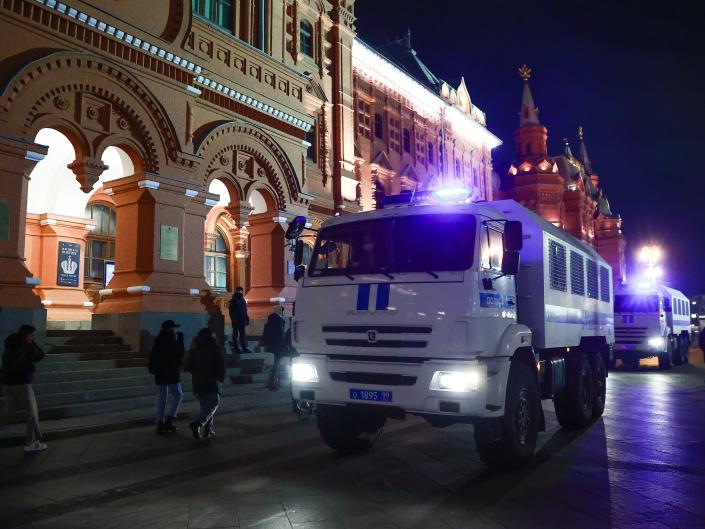 A police vehicle on a street in Moscow at night, during an unauthorized protest.