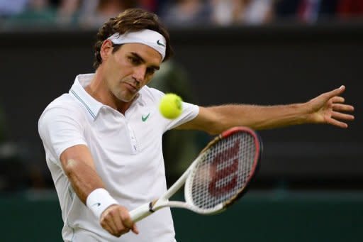 Switzerland's Roger Federer hits a backhand during his third round men's singles match against France's Julien Benneteau at the All England Tennis Club in Wimbledon, southwest London. Federer won 4-6, 6-7 (3/7), 6-2, 7-6 (8/6), 6-1 to keep alive his dreams of equalling Pete Sampras's record of seven Wimbledon titles