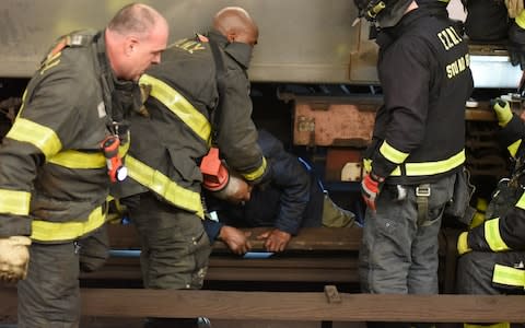 The man is pulled free from underneath the train - Credit: Christopher Sadowski