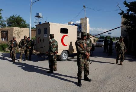 Afghan National Army (ANA) soldiers keep watch at the gate of an army headquarters after an attack in Mazar-i-Sharif, northern Afghanistan April 22, 2017. REUTERS/Anil Usyan/File Photo