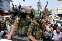 Palestinian Hamas militants attend the funeral of their comrade, in Rafah, in the southern Gaza Strip August 17, 2017. REUTERS/Ibraheem Abu Mustafa