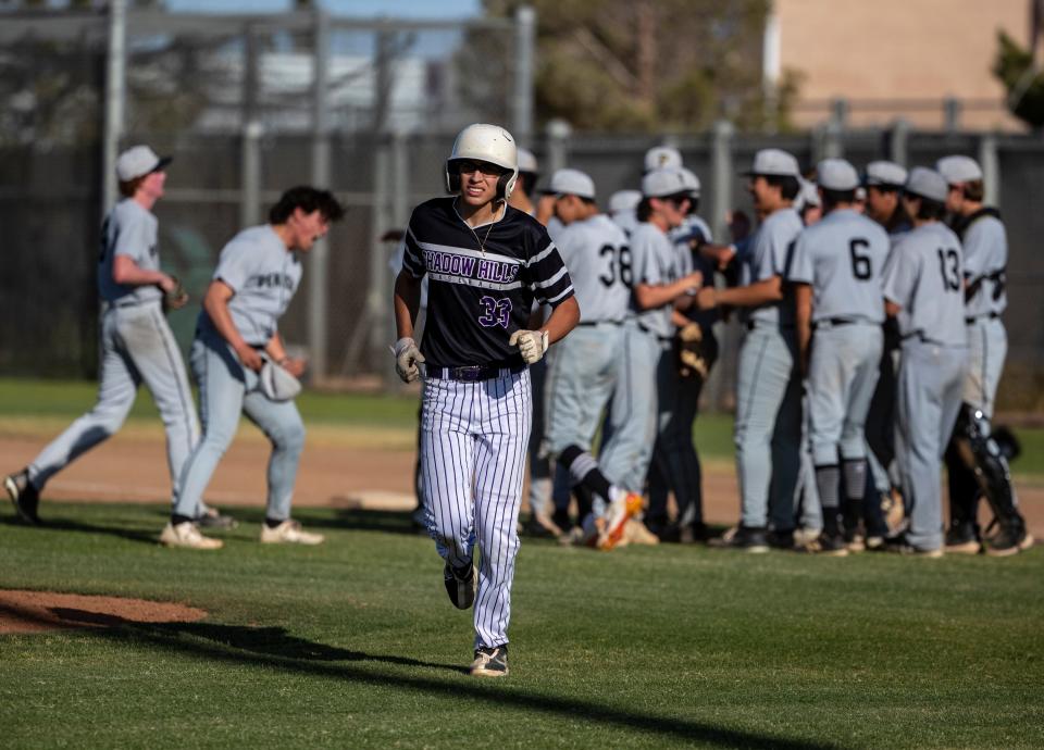 Shadow Hills' Julian Garcia (33) jogs off of first base as Peninsula players celebrate after their CIF-SS semifinal game ends with a 2-1 win for Peninsula at Shadow Hills High School in Indio, Calif., Tuesday, May 16, 2023. 