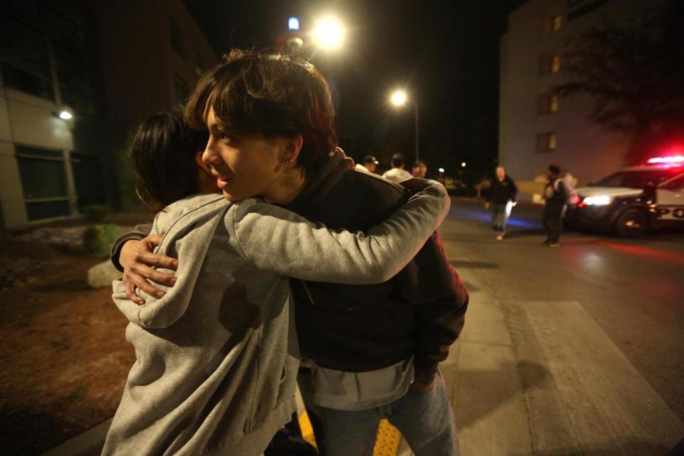 Two students hug.