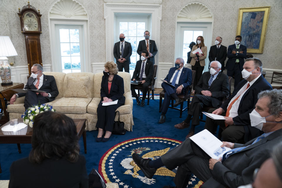 Senate Majority Leader Sen. Chuck Schumer of N.Y., left, and Democratic lawmakers fill the Oval Office of the White House to discuss a coronavirus relief package with President Joe Biden, Wednesday, Feb. 3, 2021, in Washington. (AP Photo/Evan Vucci)