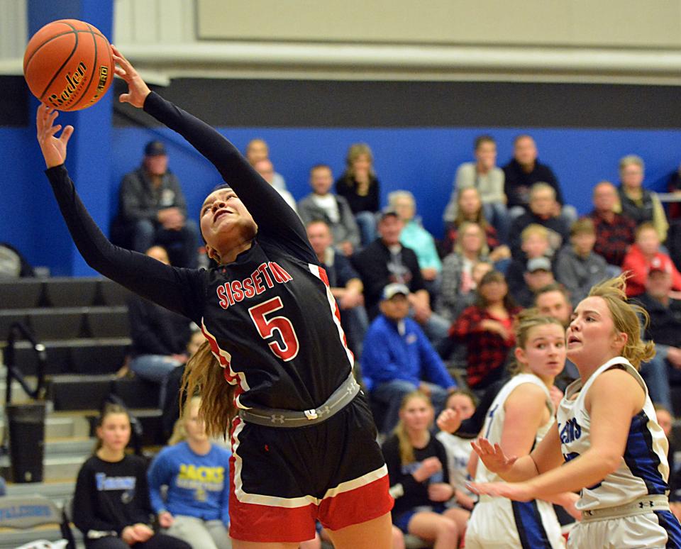 Sisseton's Alexia Quinn reaches to haul in a pass as Florence-Henry's Reese Schmidt and Griffyn Muller (right) look on during their high school girls basketball game on Thursday, Feb. 15, 2024 in Florence. Sisseton won 62-54.