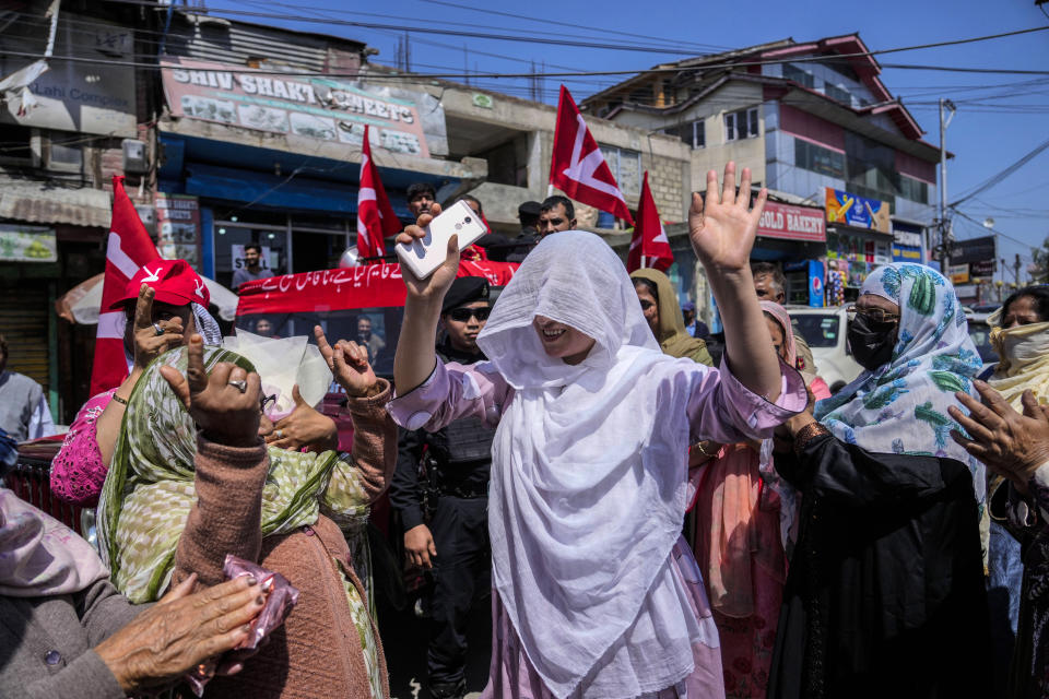 Women supporting the Jammu & Kashmir National Conference party dance during an election rally in Srinagar, Indian-controlled Kashmir, Sunday, May 5, 2024. Voting in the world's largest democracy will stretch over seven phases, with different states voting at different times and results will be announced on June 4. Over 970 million voters more than 10% of the world's population will elect 543 members for the lower house of Parliament for a term of five years. (AP Photo/Mukhtar Khan)