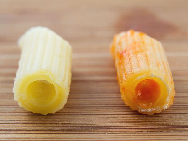 At left, pasta that's been boiled for 14 minutes; at right, pasta that also cooked for 14 minutes, first in boiling water for five minutes, then in its sauce for nine minutes. The sauce-finished pasta is less cooked (as evidenced by the white ring at its core) than the boiled pasta, despite cooking for the same amount of time.