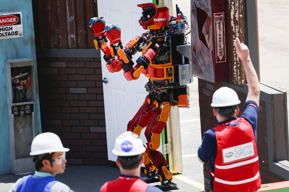 The Team Nedo-JSK robot is awarded a point after opening and walking through a door during the finals of the Defense Advanced Research Projects Agency (DARPA) Robotic Challenge in Pomona, California June 6, 2015. DARPA challenges are an example of a public-private cyber initiative.