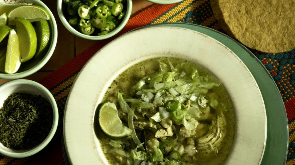 074324fo1203food posoleverde posole verde with condiments bottom left clockwise oregano, line,