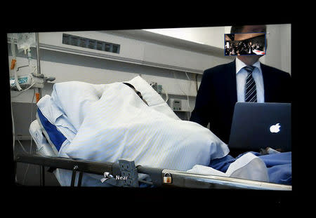 The initial remand hearing of Abderrahman Mechkah (lying in a hospital bed, attending the court session via video), 18 year-old Moroccan man suspected of killing two people and attempting to kill eight others with terrorist intent in Turku, on Friday, August 19, is held at Southwest Finland District Court in Turku, Finland, August 22, 2017. LEHTIKUVA /Martti Kainulainen via REUTERS