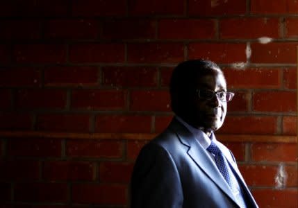 FILE PHOTO: Zimbabwe's President Robert Mugabe looks on before casting his vote in Highfields outside Harare July 31, 2013. Picture taken July 31, 2013.  REUTERS/Siphiwe Sibeko/File Photo