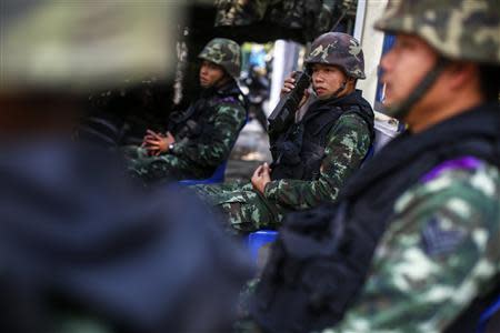 A Thai soldier uses a radio transceiver near the site of protests in Bangkok January 25, 2014. Prime Minister Yingluck Shinawatra has called a general election for Feb. 2 in the hope of cementing her hold on power in the face of more than two months of protests trying to shove her from office. Advanced polling is set to start on Sunday. REUTERS/Athit Perawongmetha