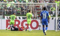 Wolfsburg's Lukas Nmecha, left, scores a goal during the German Soccer Cup match between TuS Makkabi and VfL Wolfsburg at Mommsenstadion stadium, Berlin, Sunday Aug. 13, 2023. (Andreas Gora/dpa via AP)