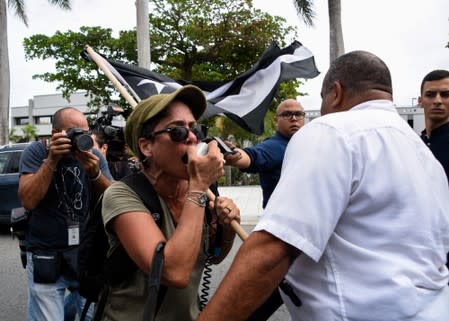 Demonstrator blocks the departing car of Pedro Pierluisi during a special session of the Legislative Assembly in San Juan