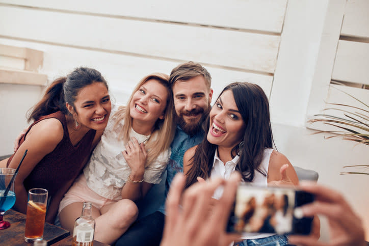 A woman taking a group picture for her friends