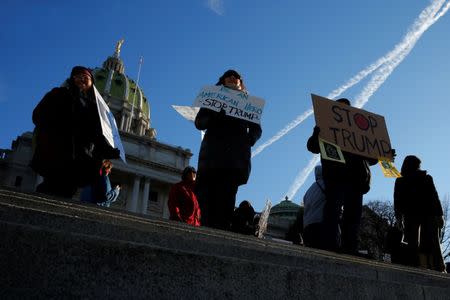 People protest against U.S. President-elect Donald Trump as electors gather to cast their votes for U.S. president at the Pennsylvania State Capitol in Harrisburg, Pennsylvania, U.S. December 19, 2016. REUTERS/Jonathan Ernst