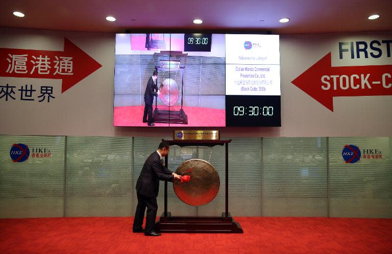 Wang Jianlin, CEO of Dalian Wanda Commercial Properties Co. opens trading at Hong Kong stock exchange on December 23, 2014