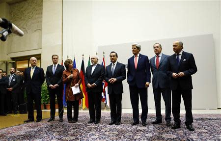 European Union foreign policy chief Catherine Ashton (3rd L) delivers a statement during a ceremony next to British Foreign Secretary William Hague, Germany's Foreign Minister Guido Westerwelle, Iranian Foreign Minister Mohammad Javad Zarif, Chinese Foreign Minister Wang Yi, U.S. Secretary of State John Kerry, Russia's Foreign Minister Sergei Lavrov and French Foreign Minister Laurent Fabius (L-R) at the United Nations in Geneva November 24, 2013. REUTERS/Denis Balibouse