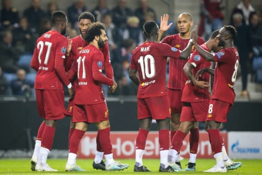 Liverpool players celebrate after Mohamed Salah scored their fourth goal against Genk