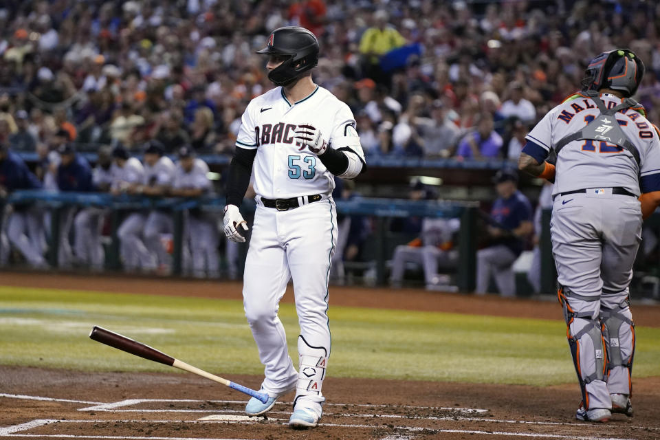 Arizona Diamondbacks' Christian Walker (53) tosses his bat down after striking out as Houston Astros catcher Martin Maldonado, right, heads back to the dugout during the first inning of a baseball game, Saturday, Sept. 30, 2023, in Phoenix. (AP Photo/Ross D. Franklin)